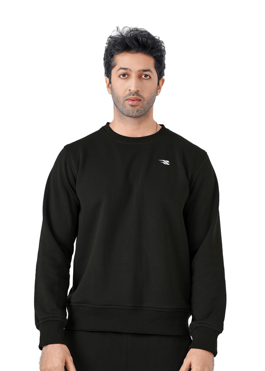 Man wearing a black sweatshirt with a brand logo on a white background