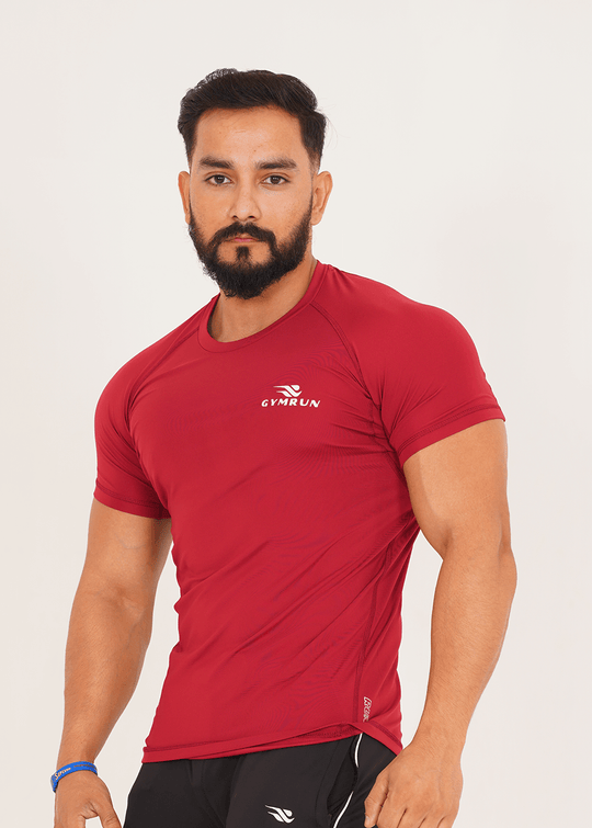 Man wearing a red athletic shirt with a visible brand logo on a white background