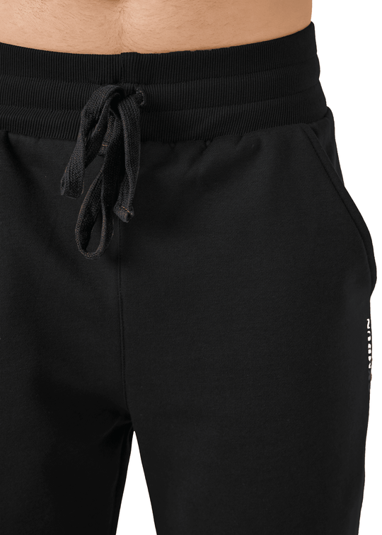 Black athletic pants with a drawstring on a white background