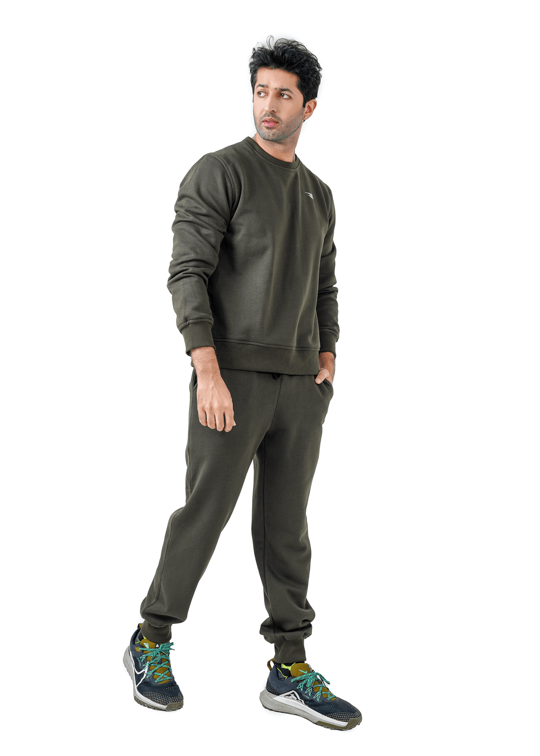 Man wearing a green tracksuit on a white background