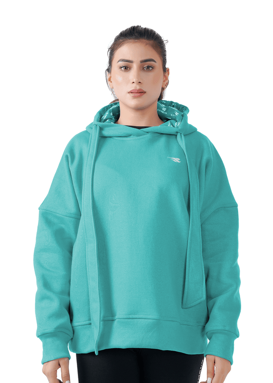 Woman wearing a teal hoodie on a white background
