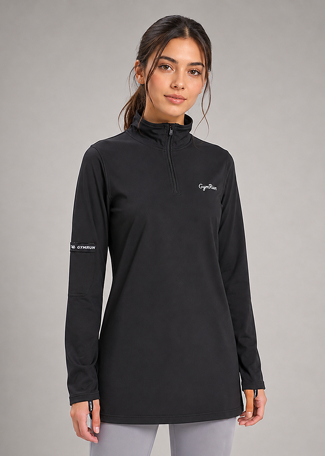 A woman modeling a black long-sleeve quarter-zip athletic pullover with 'CapeDose' printed in white on the left chest and 'ATHLETIC' on the right sleeve, set against a solid gray studio background.