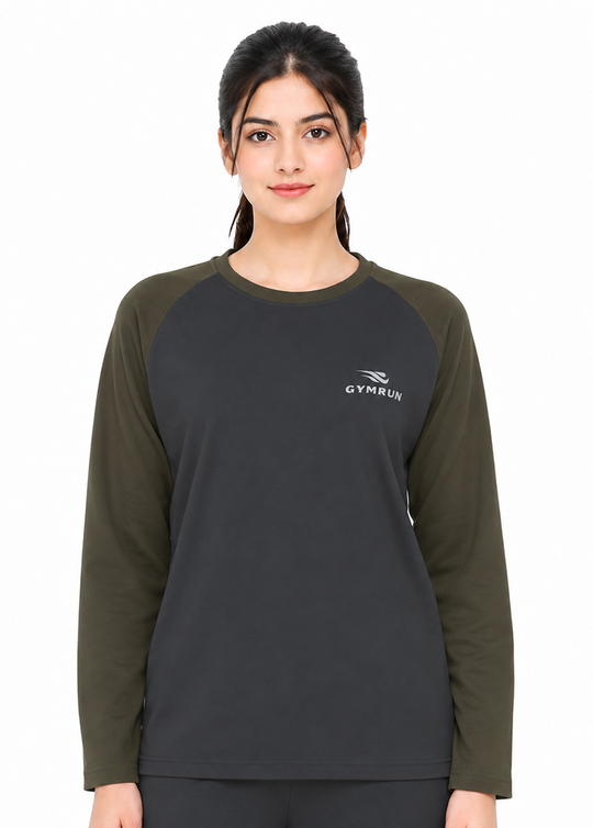 A woman modeling a long-sleeve athletic top with a dark charcoal gray body and olive green raglan sleeves. The chest features a small white GYMRUN logo.