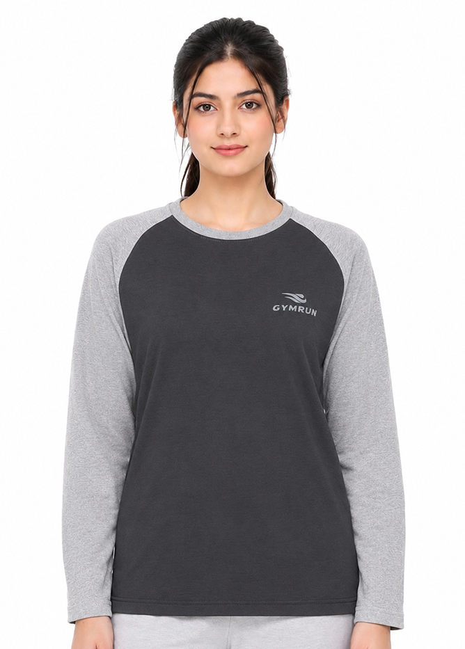 A woman modeling a dark gray and light gray raglan long-sleeve t-shirt with a small white GYMRUN logo on the left chest, set against a plain white background.
