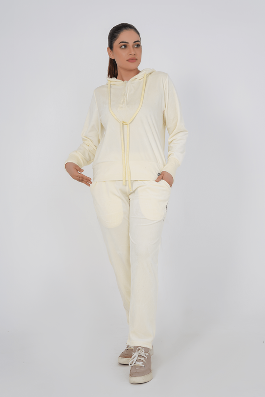Woman wearing a cream-colored outfit on a white background