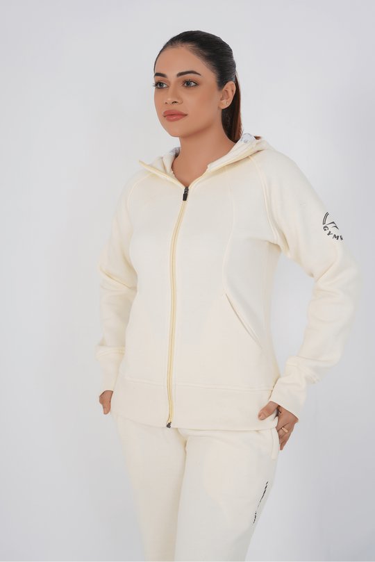 Woman wearing a cream-colored hoodie with a brand logo on a white background