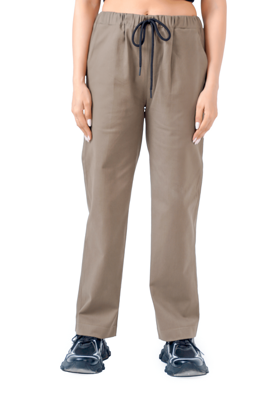 Person wearing beige pants and a black top on a white background